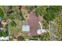 Aerial view showcasing the house roof and layout, surrounded by mature trees and greenery at 327 Sunnyside Rd, Temple Terrace, FL 33617