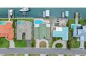An aerial view of waterfront properties with docks and pools, and well-maintained landscaping at 333 Midway Is, Clearwater Beach, FL 33767