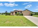 Charming home with a well-manicured lawn, fountain and a two-car garage on a sunny day at 3411 Knoxville Pl, Plant City, FL 33566