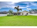 Spacious backyard with well-maintained lawn and a screened-in pool area, great for outdoor enjoyment at 4211 Elba Pl, Valrico, FL 33596