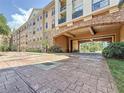 Exterior view of the building featuring an attractive brick facade and covered parking area at 4221 W Spruce St # 2218, Tampa, FL 33607