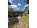 Single-story home featuring a stone facade and a quaint, landscaped front yard at 467 34Th N Ave, St Petersburg, FL 33704