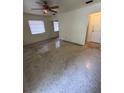 Spacious living room featuring bright walls, ceiling fan, and polished terrazzo flooring at 467 34Th N Ave, St Petersburg, FL 33704