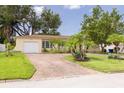 Inviting single-Gathering home with a brick driveway, attached garage, and well-maintained landscaping at 5262 25Th N Ave, St Petersburg, FL 33710