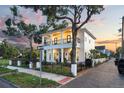 Charming two-story house with a black iron fence around the property and a second story balcony at 608 Grove N St, St Petersburg, FL 33701