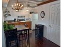 Charming kitchen with a dining table and chandelier for a cozy feel at 703/709 Patterson St, Clearwater, FL 33756