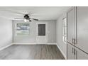 Bright, renovated living room with modern gray flooring, updated windows and a ceiling fan at 705 3Rd Ne Ave, Largo, FL 33770