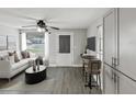 Modern living room with a sofa, a table with chairs, sleek gray flooring and a ceiling fan at 705 3Rd Ne Ave, Largo, FL 33770