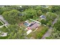 Birds-eye view of a house, pool, yard, surrounded by lush trees at 807 E Chapman Rd, Lutz, FL 33549