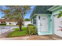 Inviting home exterior with a white front door and landscaped garden, radiating a welcoming atmosphere at 8375 Burgundy N Dr, Pinellas Park, FL 33781