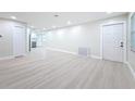Spacious living room with light wood floors and a modern, minimalist design, offering a versatile living space at 8375 Burgundy N Dr, Pinellas Park, FL 33781