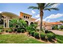 Lush landscaping surrounds the exterior of this beautiful home with a brick paved driveway at 1012 Tuscany Dr, Trinity, FL 34655
