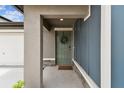 Charming front door featuring a decorative wreath, stone accents, and a 'So Happy You're Here' welcome mat at 13235 Palmerston Rd, Riverview, FL 33579