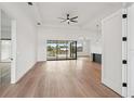 Bright and airy living room features tray ceilings, hardwood floors and expansive sliding glass doors at 15218 Appleton Blvd, Port Charlotte, FL 33981