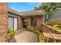 Inviting front entry with brick accents and a small garden area enhancing curb appeal at 1709 Castle Rock Rd, Tampa, FL 33612