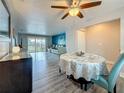 Open floor plan with dining area transitioning to living room with sliding door access to balcony at 200 Country Club Dr # 202, Largo, FL 33771