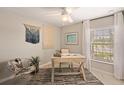 Bright home office space with a large window, neutral tones, and a decorative accent chair at 20214 Banner Ave, Port Charlotte, FL 33952