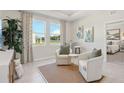 Bright sitting area with large windows, elegant curtains, and comfortable furniture at 2238 Stratten Dr, Zephyrhills, FL 33541