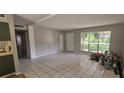 Bright living room with tile floors, large window, and neutral paint at 2503 Elm St, Seffner, FL 33584