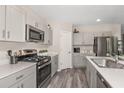 This kitchen features stainless appliances, gray cabinets and plenty of counter space at 37106 Sagemoor Dr, Zephyrhills, FL 33541