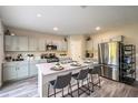 Bright eat-in kitchen featuring a large island with seating and stainless steel appliances at 37106 Sagemoor Dr, Zephyrhills, FL 33541