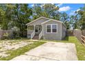 Well-maintained home with a driveway and cozy front porch at 3953 10Th S Ave, St Petersburg, FL 33711