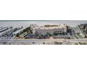 Stunning aerial view of the condo complex next to the beach, with a parking lot at 4450 Gulf Blvd # 110, St Pete Beach, FL 33706