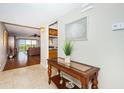 Inviting entryway featuring tile floors, a decorative table, and an open view to the living room at 4450 Gulf Blvd # 110, St Pete Beach, FL 33706