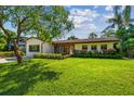 Beautiful single-story home showcases a vibrant green lawn, manicured landscaping, and a classic design at 4522 S Hale Ave, Tampa, FL 33611