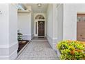 Inviting front entrance with tiled porch and decorative front door at 6051 65Th N Ave, Pinellas Park, FL 33781