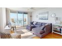 Bright living room with modern furnishings, balcony access, and water views at 6105 Bahia Del Mar Cir # 682, St Petersburg, FL 33715