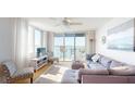 Bright living room with modern furnishings, balcony access, and water views at 6105 Bahia Del Mar Cir # 682, St Petersburg, FL 33715