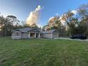 Well-maintained single-Gathering home with a spacious front yard, driveway, and a neatly manicured lawn at 6153 La Pine Rd, Brooksville, FL 34602