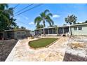 A delightful backyard features a decorative grass pad and a spacious screened-in porch with elegant tile flooring at 6912 14Th N St # 6912, St Petersburg, FL 33702