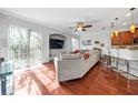 Cozy living room with hardwood floors and sliding doors to the outdoor area at 7001 Interbay Blvd # 192, Tampa, FL 33616