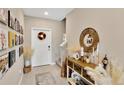 Elegant foyer with a console table, decorative mirror, and a gallery wall of Gathering photos at 7017 Gomez Rocks Ct, Sun City Center, FL 33573