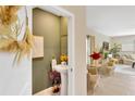 Charming powder room featuring a pedestal sink, decorative mirror, and stylish olive green walls at 7017 Gomez Rocks Ct, Sun City Center, FL 33573