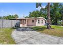 Exterior view of home with curved driveway and mature trees, offering a glimpse of suburban living at 7676 18Th St N, St Petersburg, FL 33702