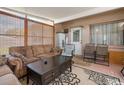 Inviting sunroom with cozy furniture, bamboo shades, and ample natural light, blending indoor comfort with outdoor views at 7676 18Th St N, St Petersburg, FL 33702