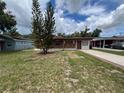 Charming single-story home with brick facade and a covered porch, complemented by a well-maintained front yard at 9218 N 52Nd St, Tampa, FL 33617