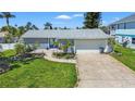 Well-maintained single-story home with a lush front yard and inviting curb appeal at 9917 San Sierra Way, Port Richey, FL 34668