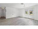 Bright, open living room featuring tile floors and double french doors at 9917 San Sierra Way, Port Richey, FL 34668