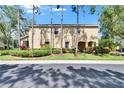 Inviting two-story home surrounded by lush greenery and mature trees, offering a serene curb appeal at 10606 Shady Falls Ct, Riverview, FL 33578