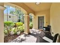 Welcoming front porch with cozy seating, decorative welcome sign, and well-maintained landscaping at 10606 Shady Falls Ct, Riverview, FL 33578