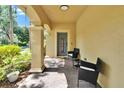 Inviting front porch featuring outdoor seating and a stylish welcome sign at 10606 Shady Falls Ct, Riverview, FL 33578