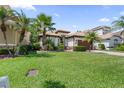 A well-kept lawn enhances this single-story home with tile roof and paver driveway at 10880 Cory Lake Dr, Tampa, FL 33647