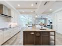 Bright kitchen featuring stainless steel appliances, a large island with marble countertops, and white cabinetry at 1204 Derby Ln, Sarasota, FL 34242