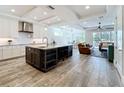 Spacious kitchen with a large island, modern appliances, and an open floor plan leading to the living room at 1204 Derby Ln, Sarasota, FL 34242