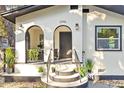 Inviting front entrance with well-maintained landscaping, arched entry, and steps to the front door at 1206 E Osborne Ave, Tampa, FL 33603