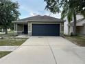 Charming single-story home with a two-car garage and well-manicured lawn at 15421 Shoal Haven Pl, Ruskin, FL 33573